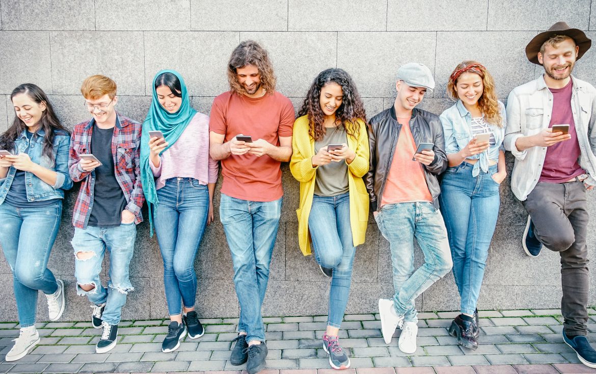 Group,Of,Fashion,Friends,Watching,On,Their,Smart,Mobile,Phones
